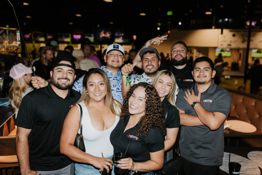 Group of coworkers pose and smile for a photo during a company outing